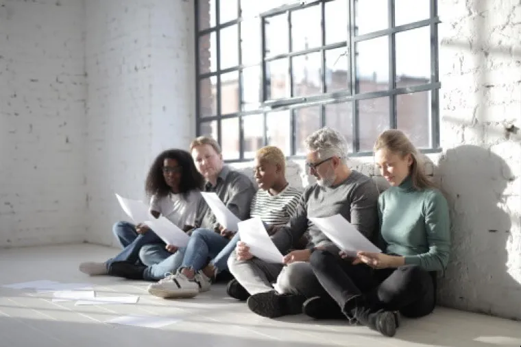 An illustration of candidates holding their resumes.