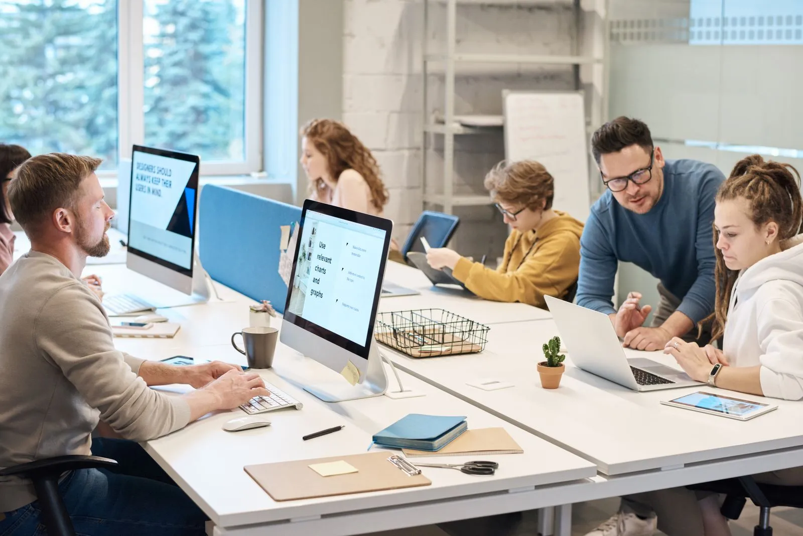 A team working together at computers in a modern office