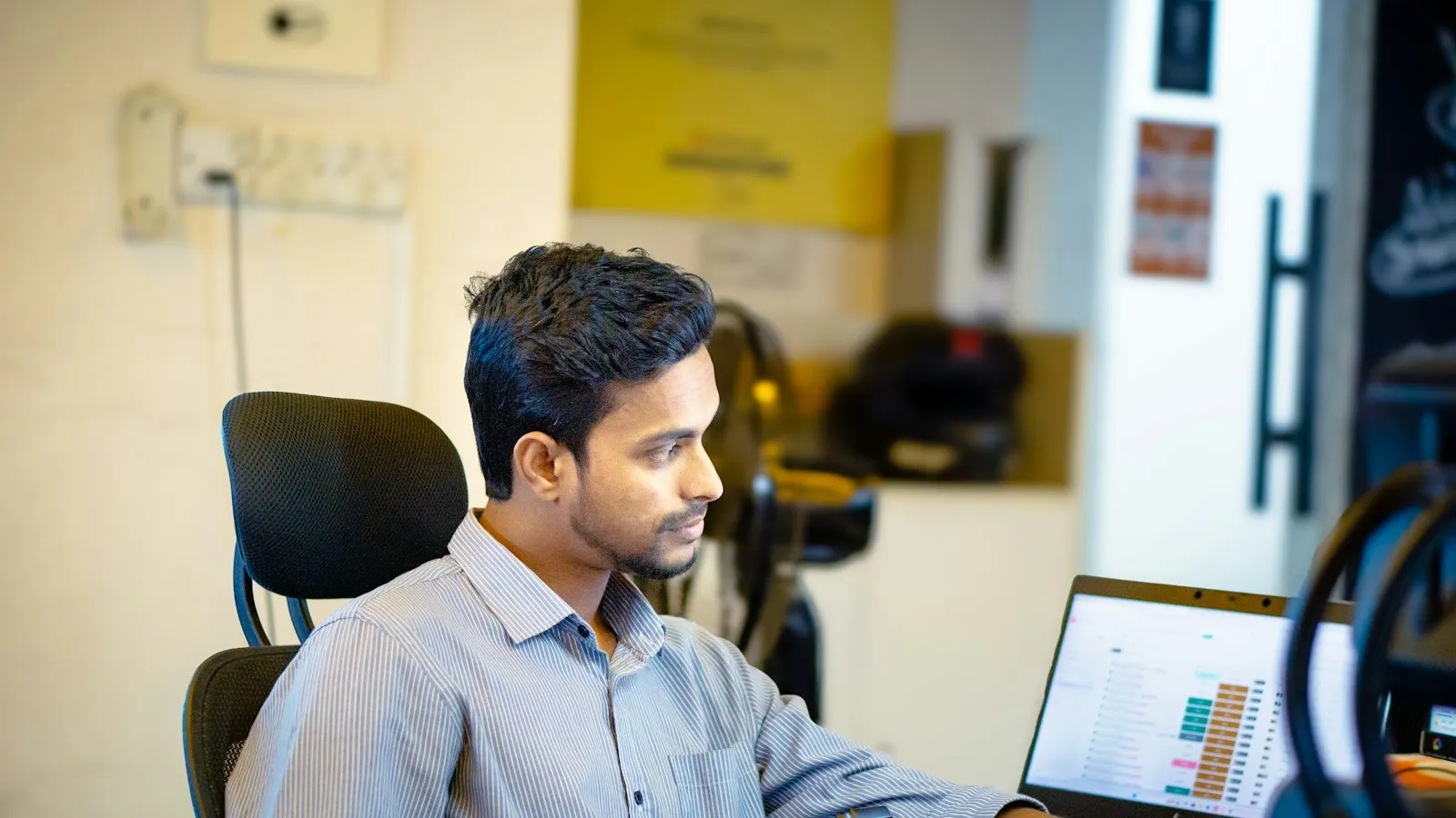 A man sitting in front of a laptop on a video call